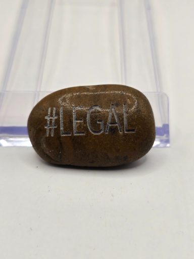 laser engraved river rock with word #legal