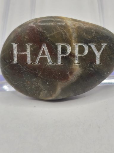 laser engraved river rock with word happy