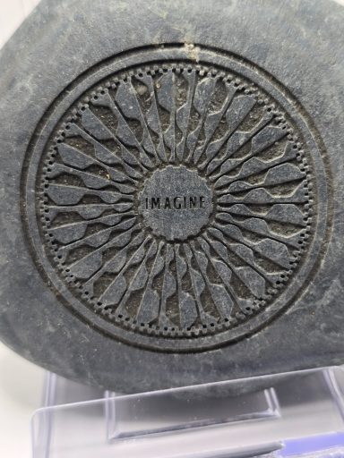 laser engraved river rock with strawberry fields imagine design